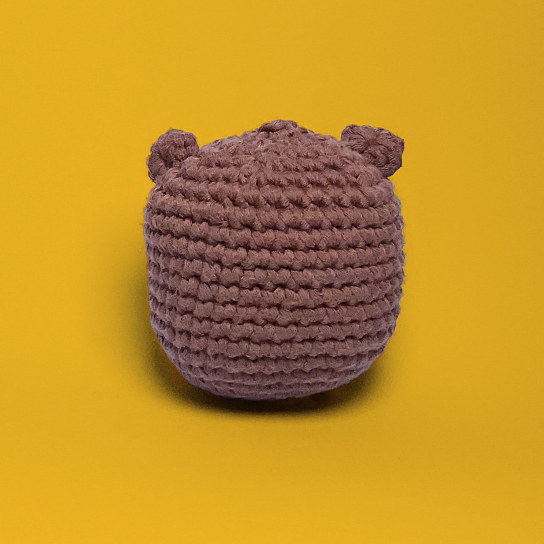 Brown bear crochet amigurumi, a completed project from our beginner-friendly crochet kit. Handmade with our yarn, perfect for people who are looking to learn crocheting. Back view.