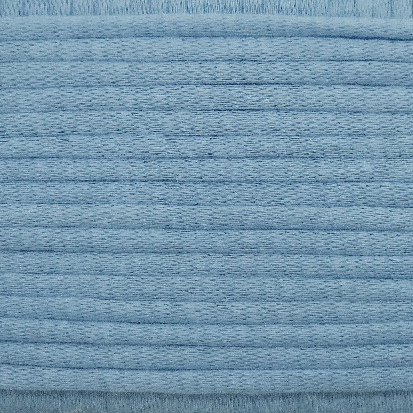 A close-up image showing the texture of a sky blue coloured yarn that is friendly for crochet beginners.