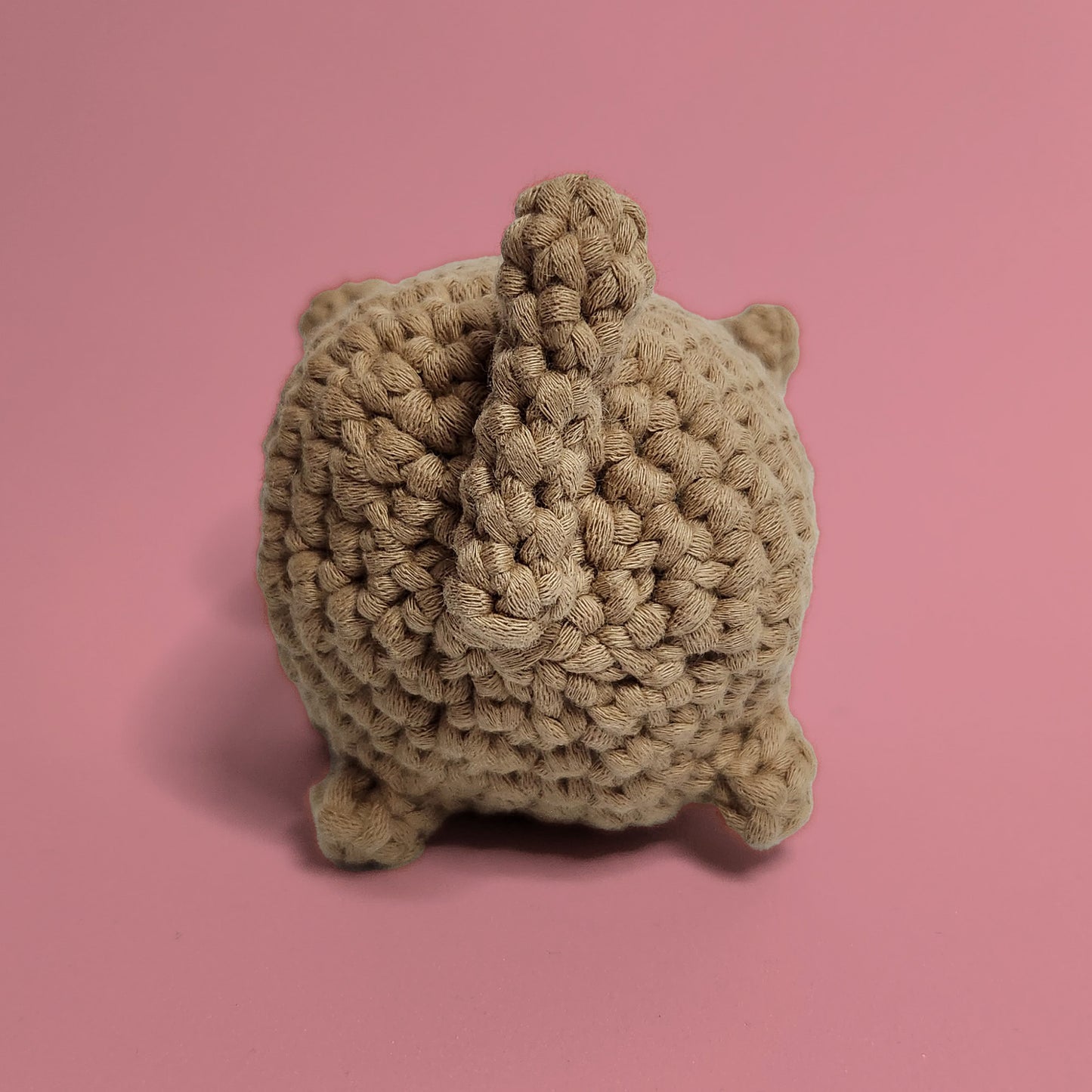 Brown cat crochet amigurumi with whiskers and ears. Handcrafted with care, this charming cat is a purr-fect project for cat lovers and crochet enthusiasts. Back view.