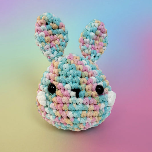 Bunny crochet amigurumi from rainbow pastel yarn, handmade from our beginner crochet kit. Perfect as a handmade gifts for friends. Front view.