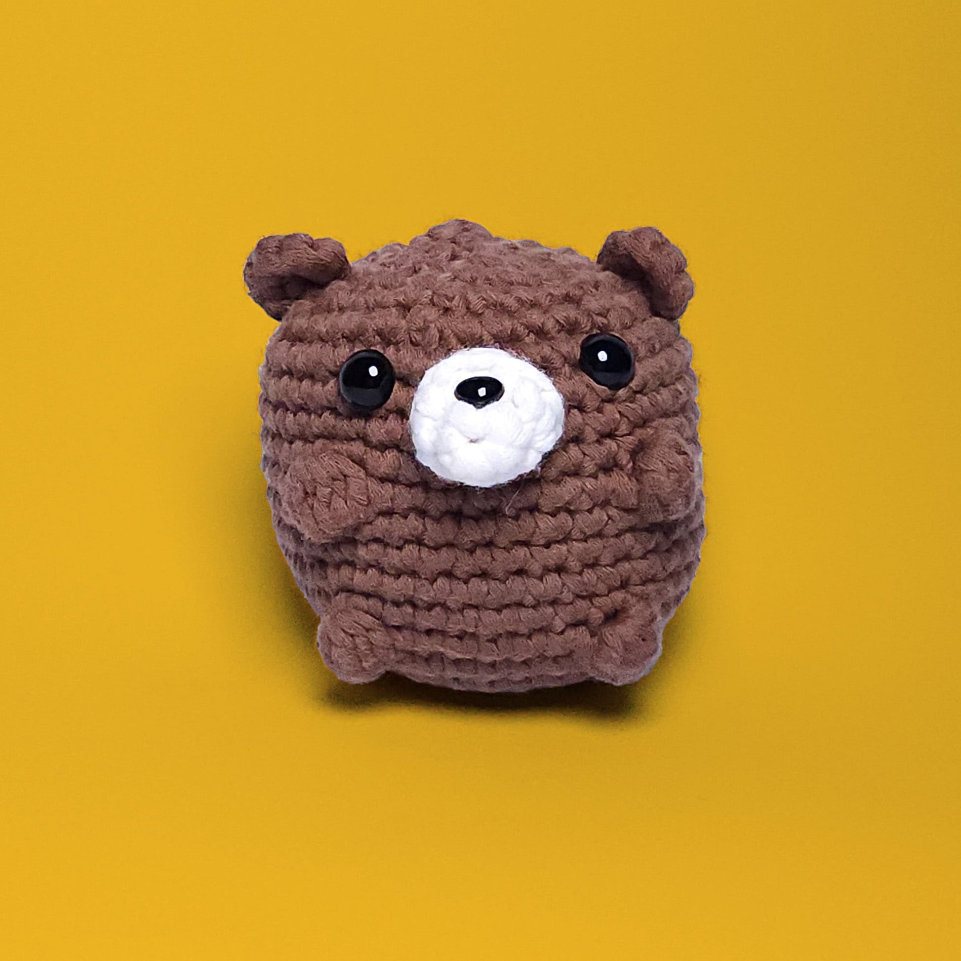 Brown bear crochet amigurumi, a completed project from our beginner-friendly crochet kit. Handmade with our yarn, perfect for people who are looking to learn crocheting. Front view.