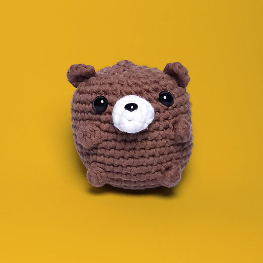 Brown bear crochet amigurumi, a completed project from our beginner-friendly crochet kit. Handmade with our yarn, perfect for people who are looking to learn crocheting. Front view.