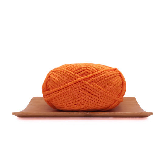 A skein of fire orange coloured yarn for crochet beginners.