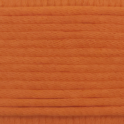 A close-up image showing the texture of a fire orange coloured yarn that is friendly for crochet beginners.