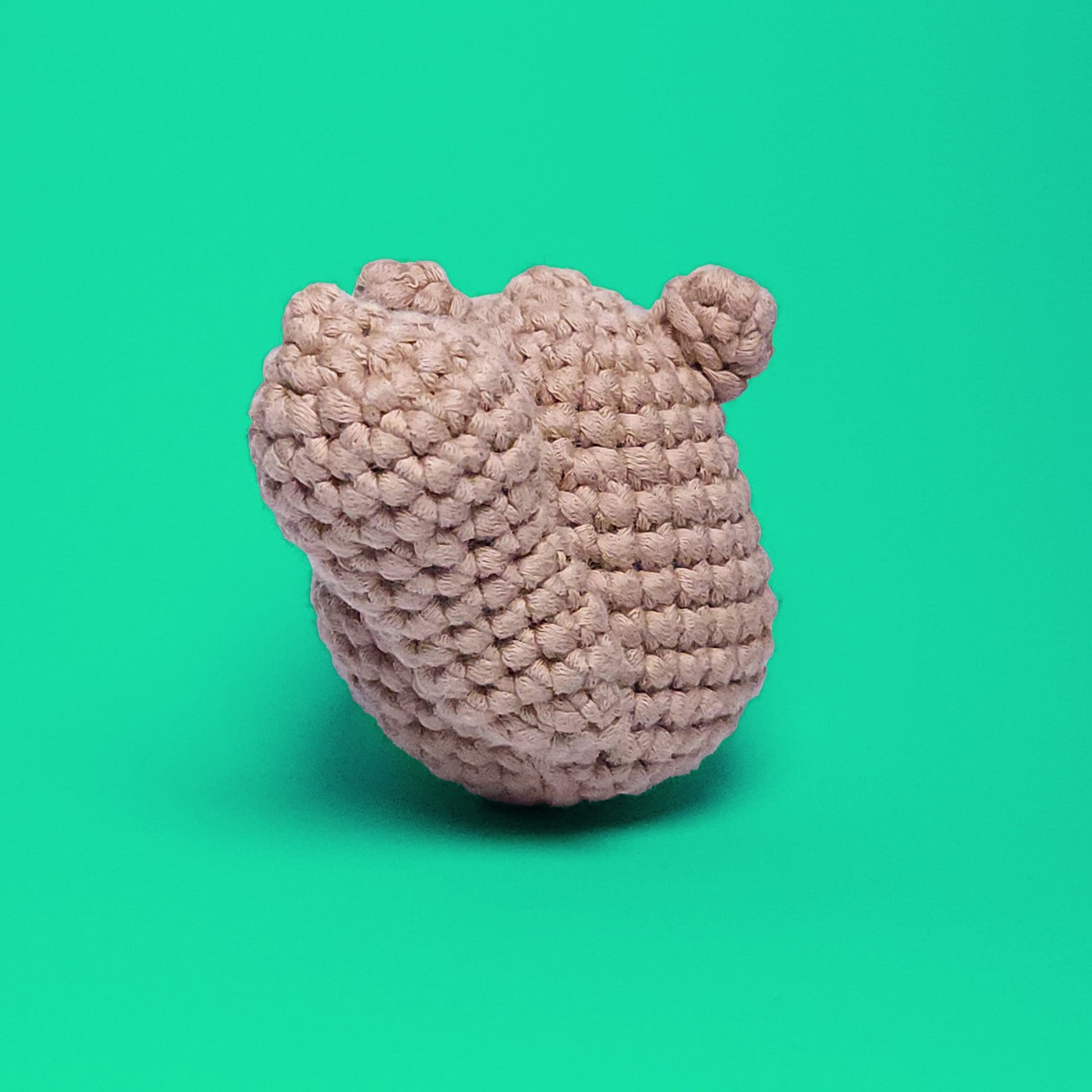 Cute beaver amigurumi, crafted from our beginner-friendly crochet kit. Perfect for crochet enthusiasts looking to create adorable projects. Back view showcasing its big fluffy tail.