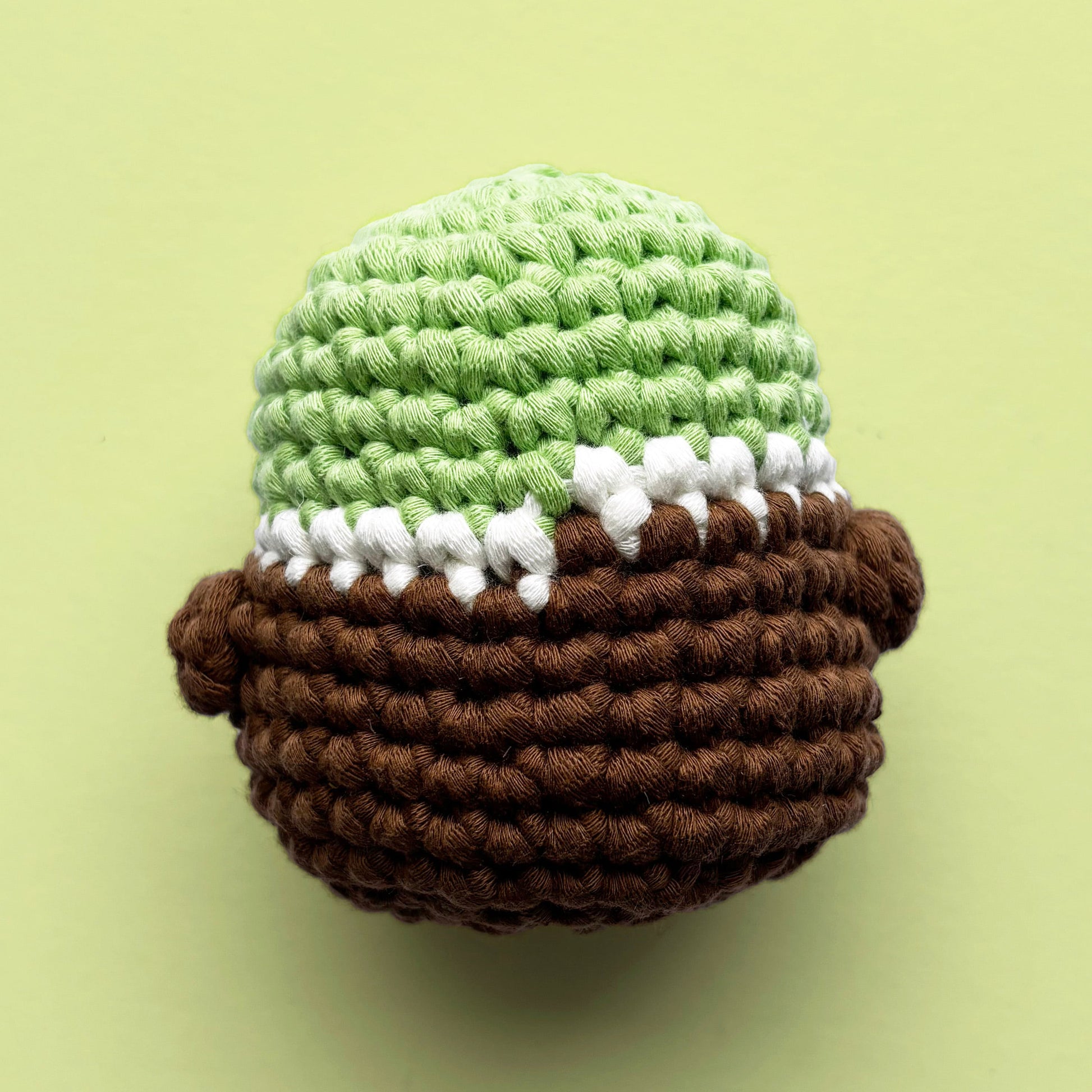 Louie the crochet duck, featuring vibrant green, white, and dark brown colors. Handcrafted from our beginner-friendly crochet kits, perfect for beginners and duck lovers. Back view.