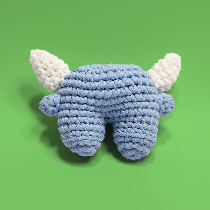 Nero, the fearsome aqua monster crochet amigurumi, featuring a striking blue color with fangs and horns. Handcrafted with attention to detail, Nero is a unique and adventurous project perfect for crafters looking for a challenge. Back view.