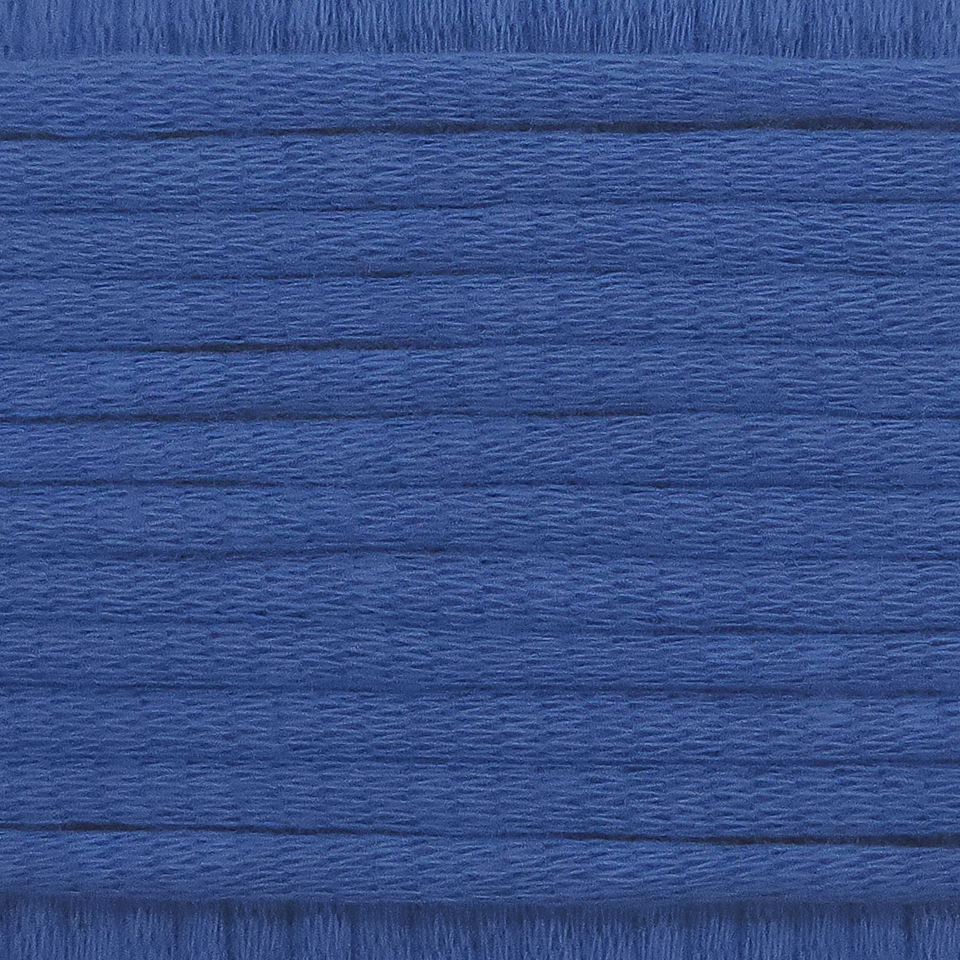 A close-up image showing the texture of a royal blue coloured yarn that is friendly for crochet beginners.