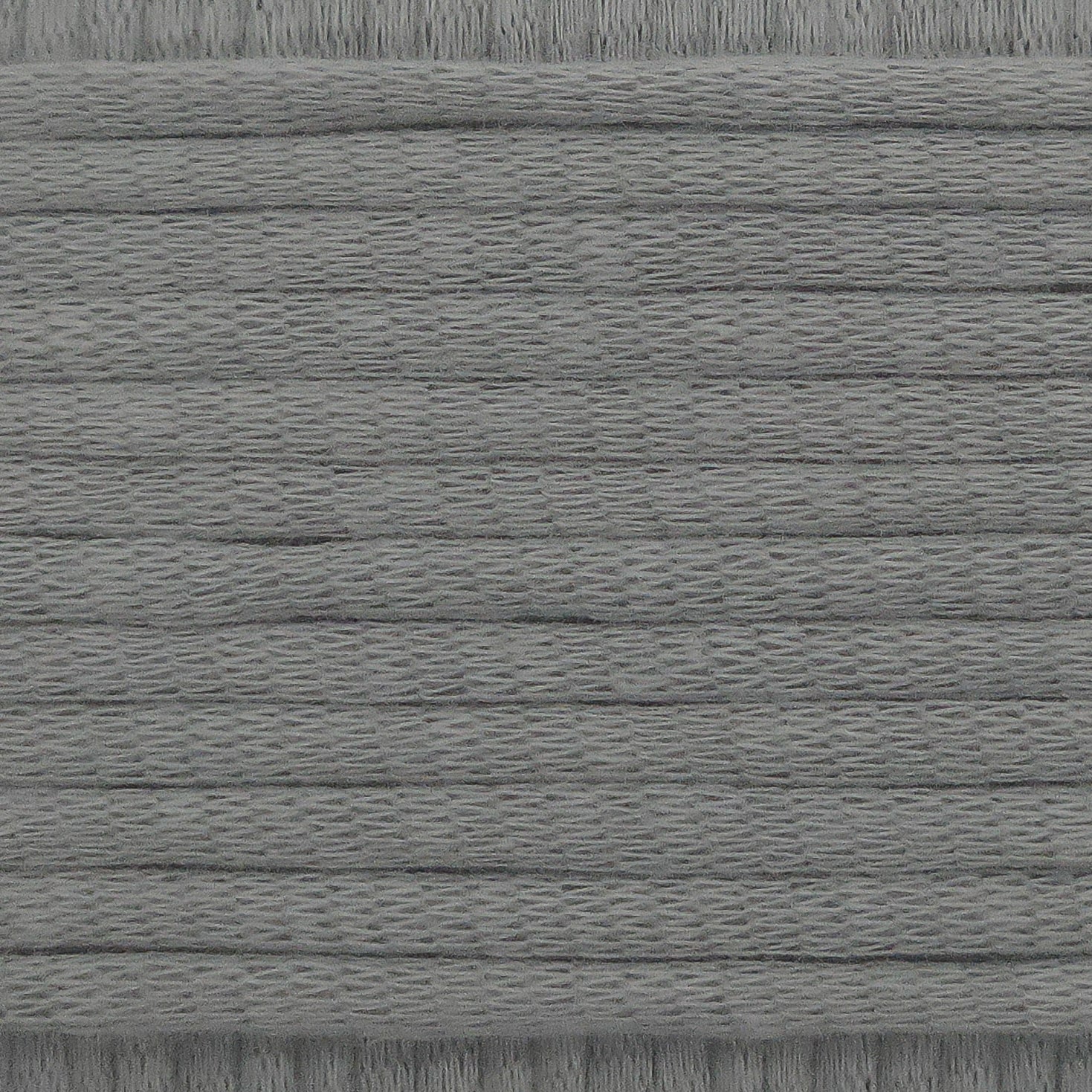 A close-up image showing the texture of a soft grey coloured yarn that is friendly for crochet beginners.
