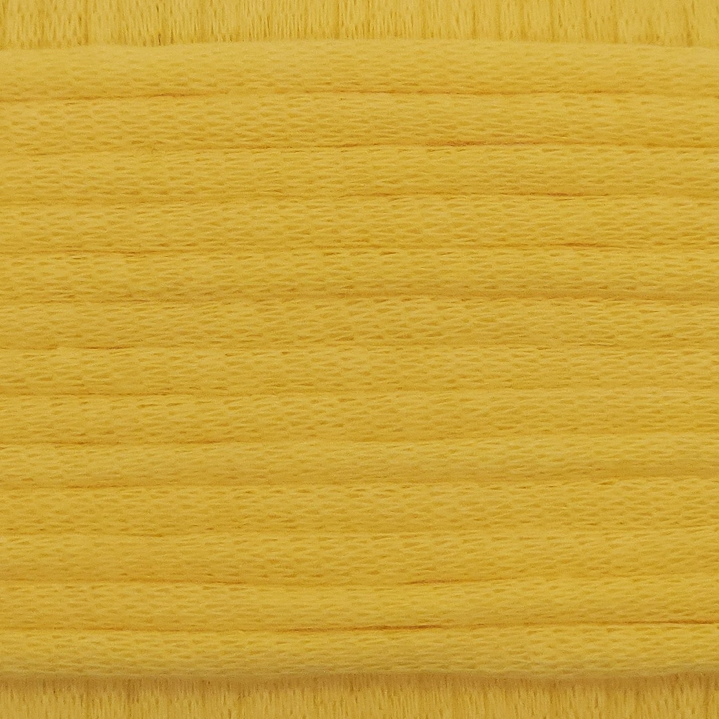 A close-up image showing the texture of a sunshine yellow coloured yarn that is friendly for crochet beginners.