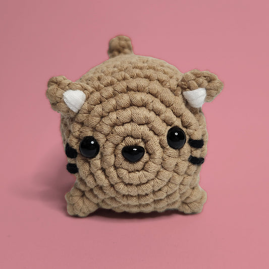 Brown cat crochet amigurumi with whiskers and ears. Handcrafted with care, this charming cat is a purr-fect project for cat lovers and crochet enthusiasts. Front view.