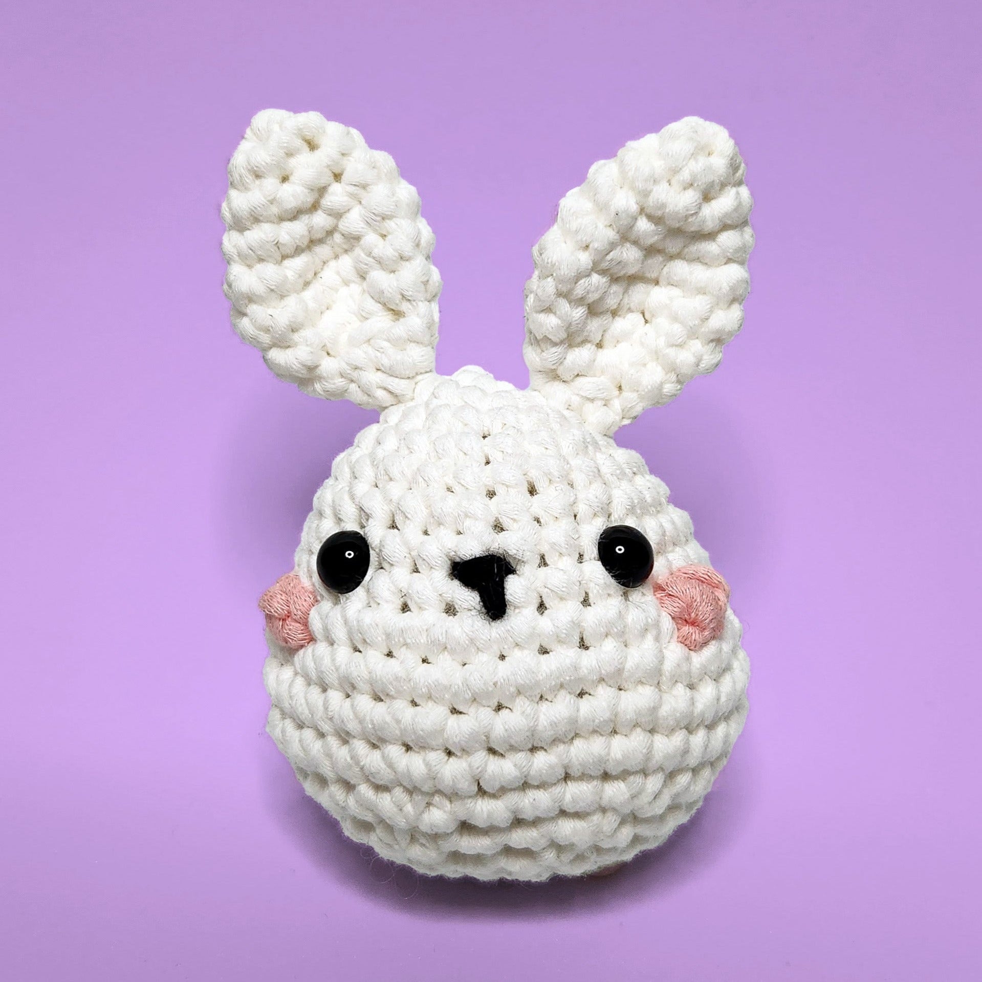 White bunny crochet amigurumi, handmade from our beginner crochet kit. Perfect as a handmade gifts for friends. Front view.